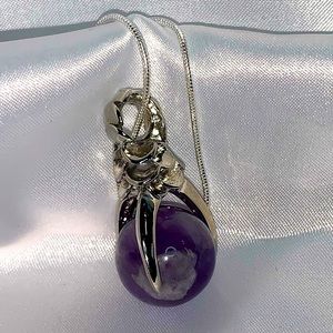 Amethyst ball with Silver dragon claw necklace.